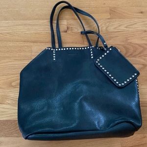 Black shoulder bag with gold grommet studs.